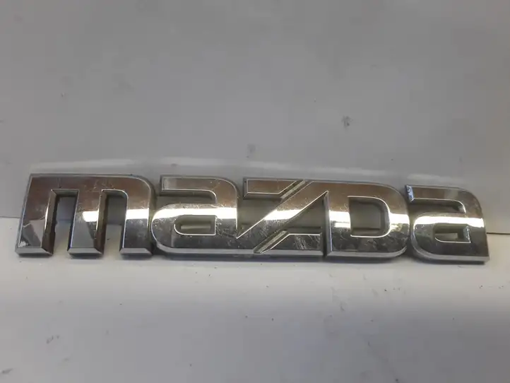 Mazda Premacy (1999 - 2005) Эмблема производителя — фото 1